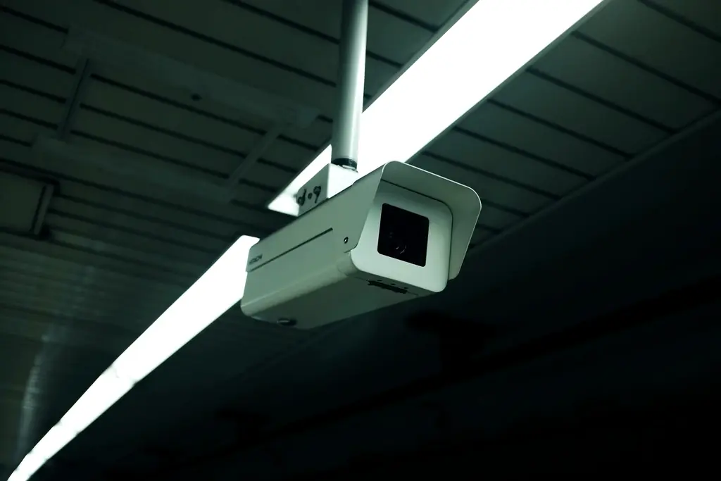 Surveillance camera mounted on a ceiling in low light
